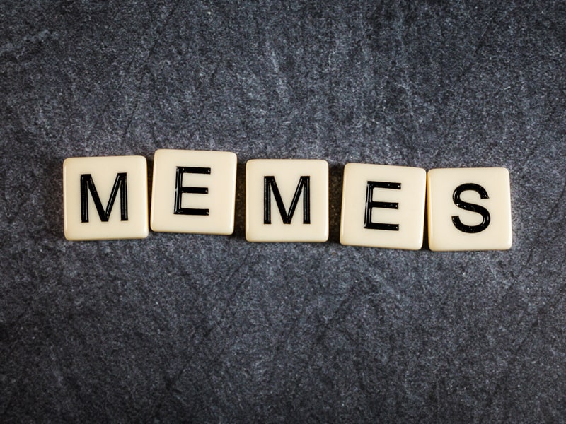 memes-and-blogs-letter-tiles-on-black-slate-background-spelling-memes-min