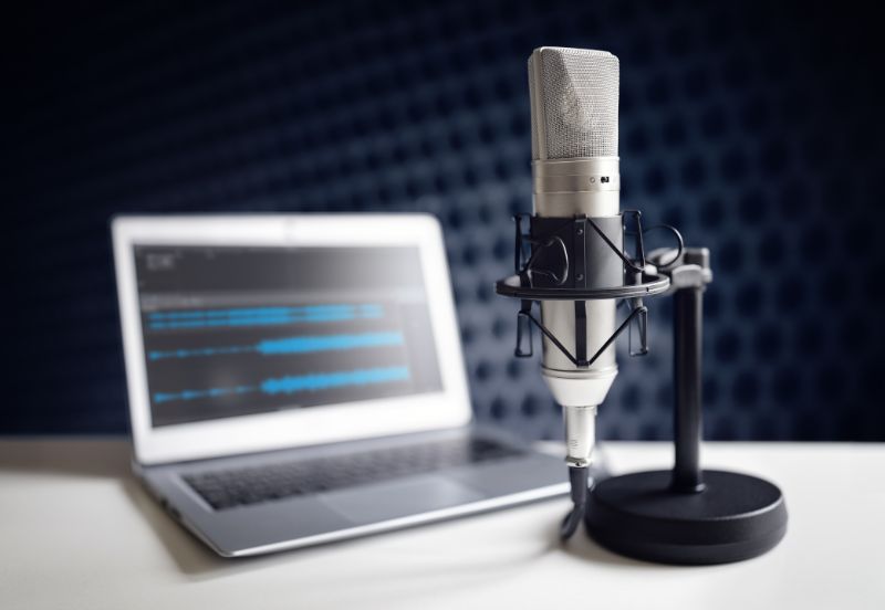 transcription-company-podcast-microphone-and-laptop-min