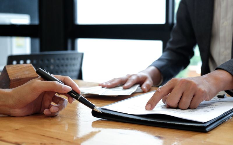 sworn translator-real-estate-brokers-pointed-to-signing-agreement-documents-min