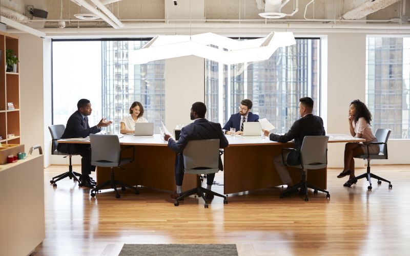 document-translation-services-south-africa-group-of-business-professionals-meeting-around-table-in-modern-office-min