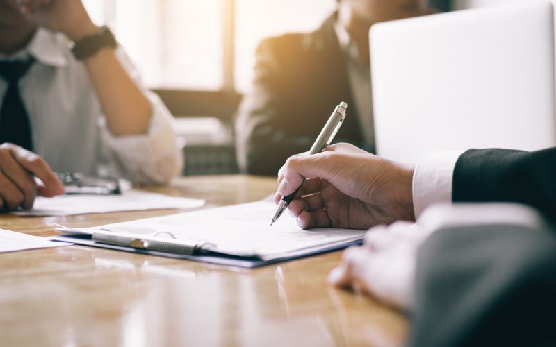 sworn-translator-boardroom-with-human-resource-business-people-writing-paper-negotiating-a-contract-min